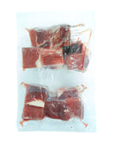 Vacuum-sealed packages of raw beef on a white background