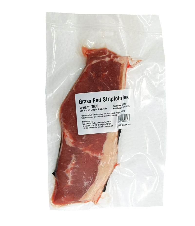Grass fed striploin steak in a clear plastic bag with a label on a white background