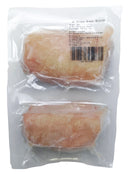 Two packages of chicken breast in a clear plastic bag with a white background