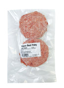 Two raw Wagy beef patties in a clear plastic packaging with a label.