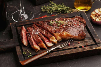 Pan-seared grass-fed striploin steak sliced to show medium-rare doneness
